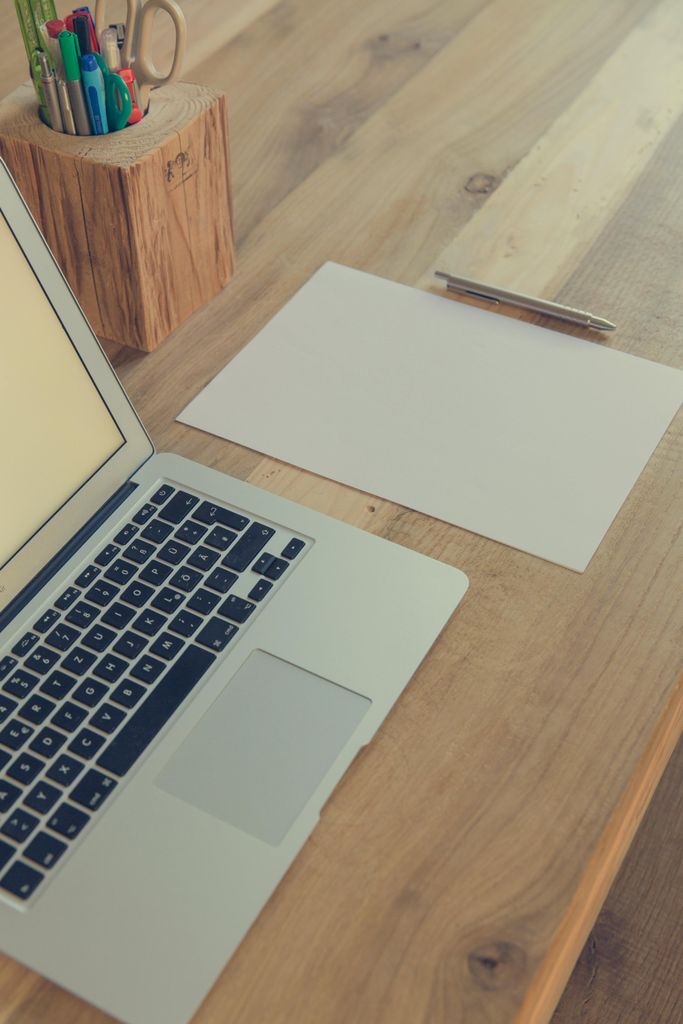 Macbook Pro on Brown Wooden Table